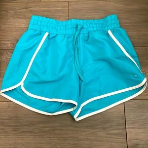 Turquoise running shorts.